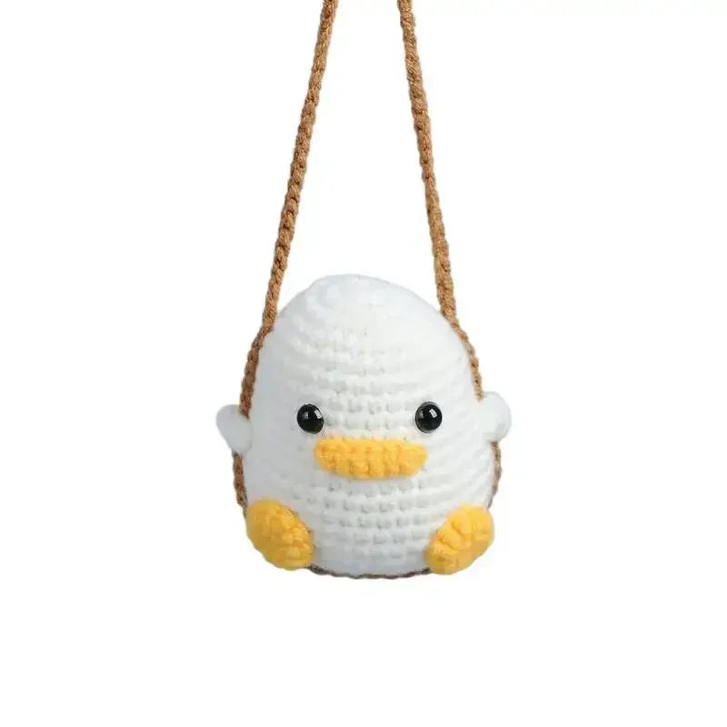 Handmade crochet animal car hanging ornament with a white body and yellow feet