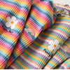 Close-up of a girls striped floral print cotton t-shirt featuring a white flower design.