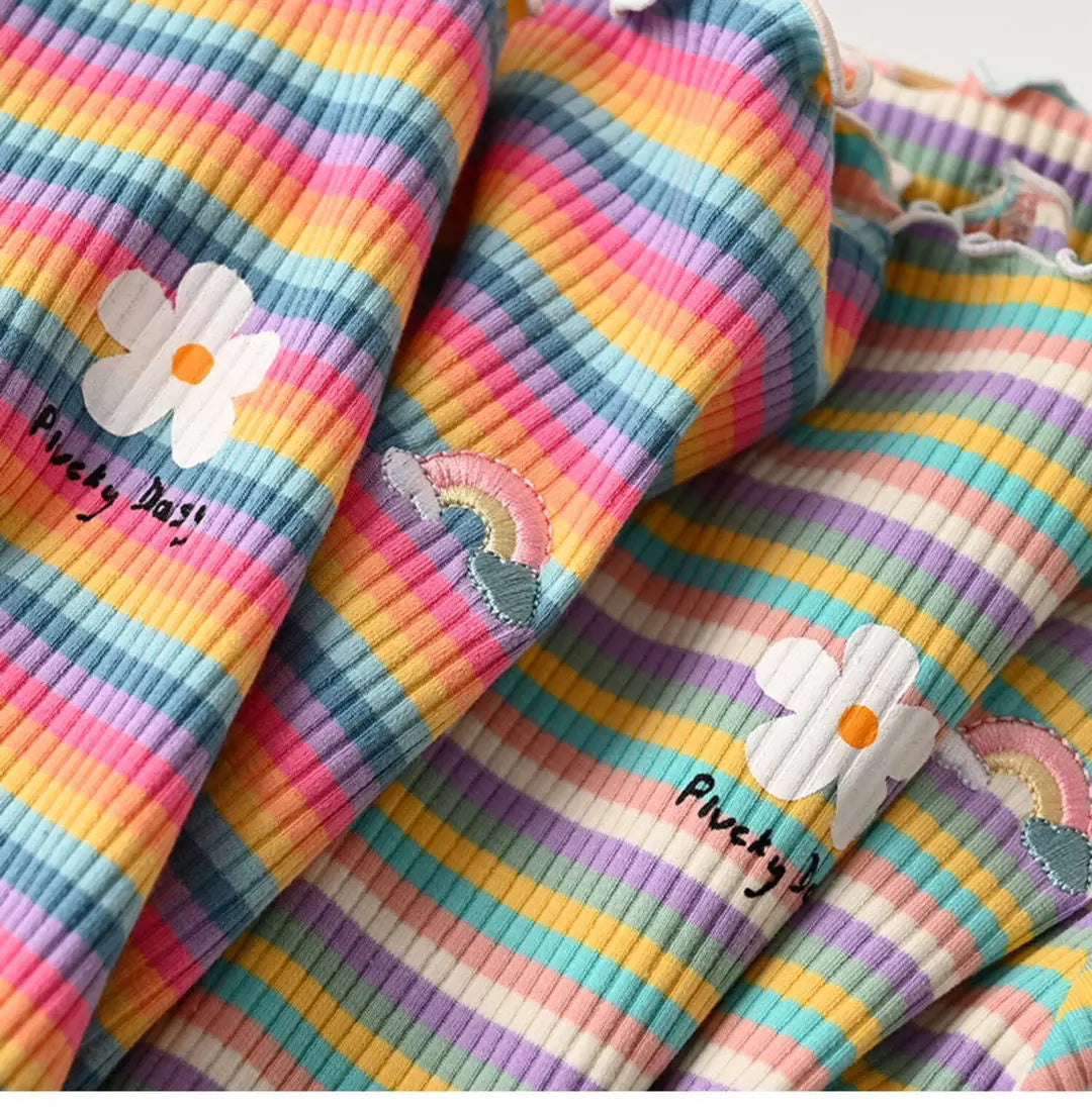 Close-up of a girls striped floral print cotton t-shirt featuring a white flower design.