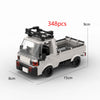 A white LEGO-style building block model of a pickup truck with a cab and open bed, shown from the side.