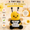 A yellow crochet bee doll with black accents and a heart-shaped card for mom