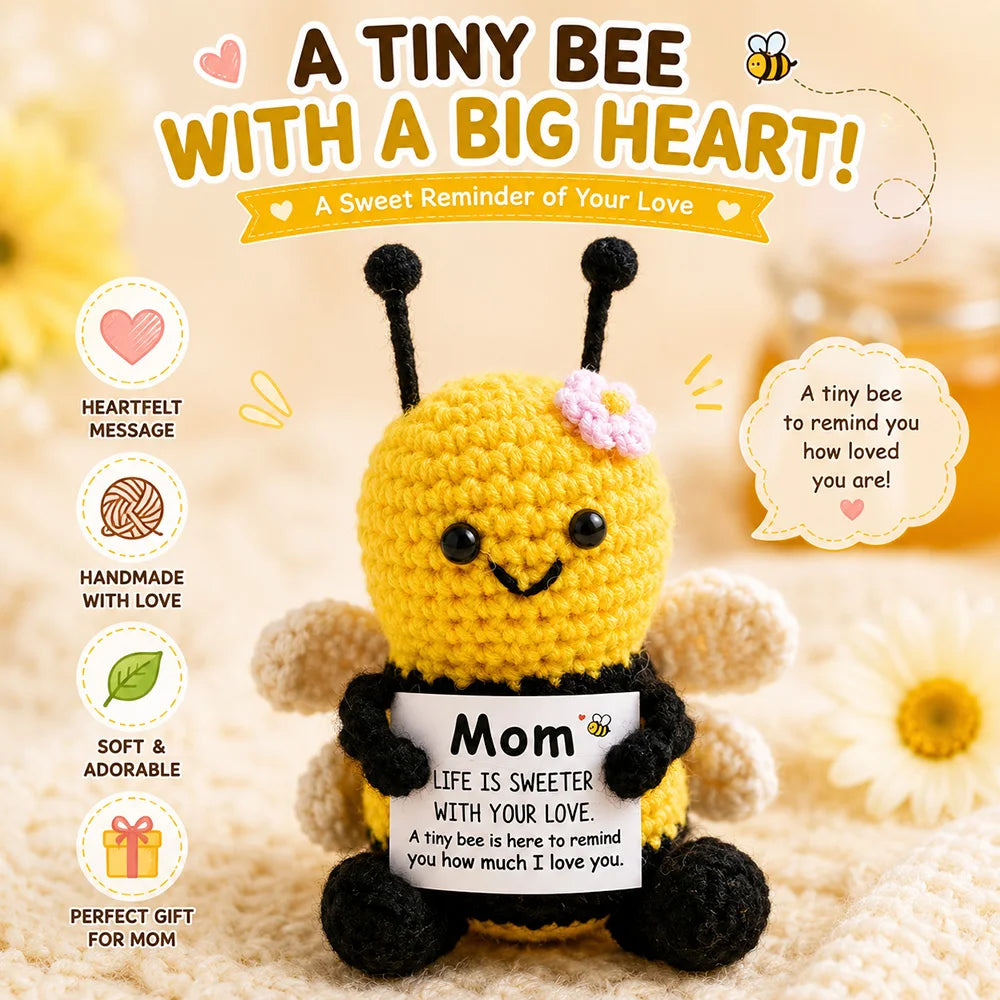 A yellow crochet bee doll with black accents and a heart-shaped card for mom