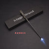 A dark wooden magic wand with a glowing LED tip is displayed on a dark surface.
