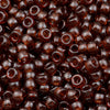 A close-up view of small, dark amber pony beads for jewelry making and crafts.