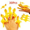 A hand is holding and launching yellow catapult chicken flying toys onto a white background.