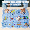 A child's hands are assembling a puzzle car made of interlocking plastic pieces that form an electric track.