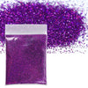 A small package of vibrant purple holographic glitter powder scattered across a white background.