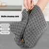 A hand is holding a gray waffle cleaning cloth, demonstrating its absorbent and oil-resistant features.