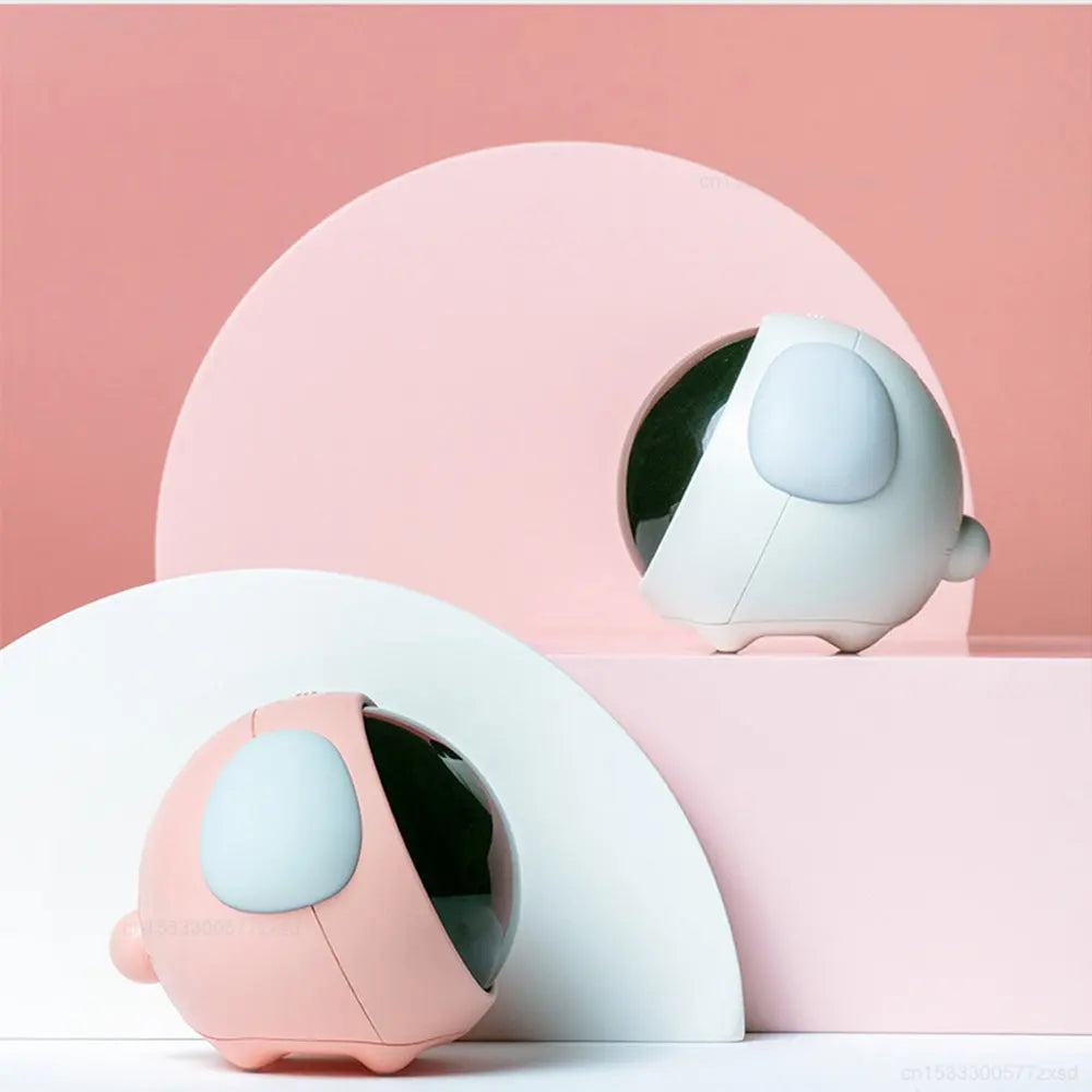 A pink and white cute emoji alarm clock with a night light is displayed against a soft pink background.