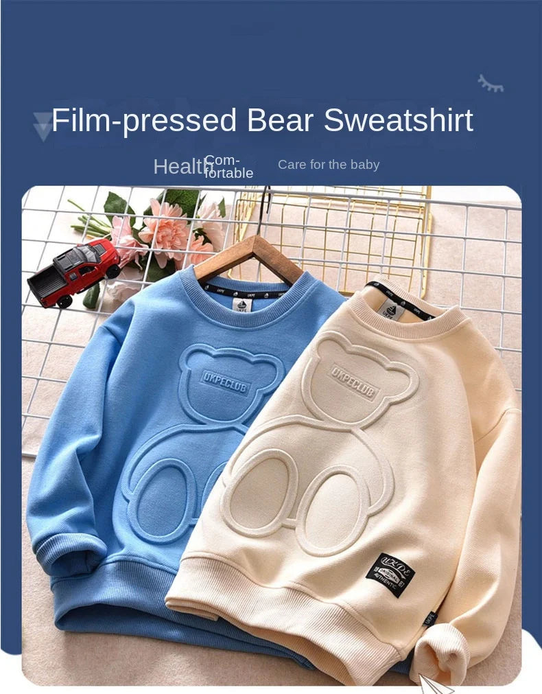 A blue film-pressed bear sweatshirt and a cream-colored bear sweatshirt are displayed on a light background.