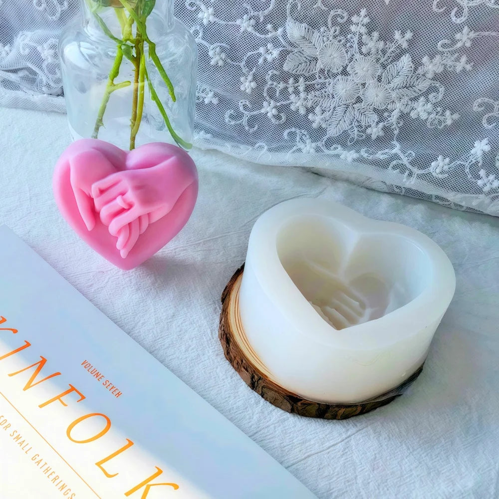 Pink heart-shaped silicone mold resting on a white cloth next to a natural wood slice.
