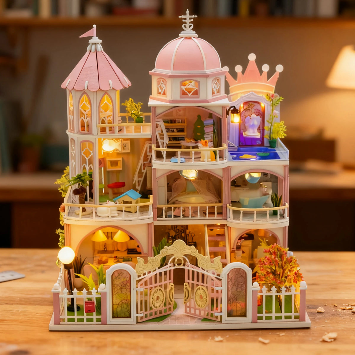 A detailed wooden dollhouse kit of a castle with multiple floors, LED lighting, and furniture.