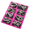A pink plastic tray holding eight silver metal brain teaser puzzle rings.
