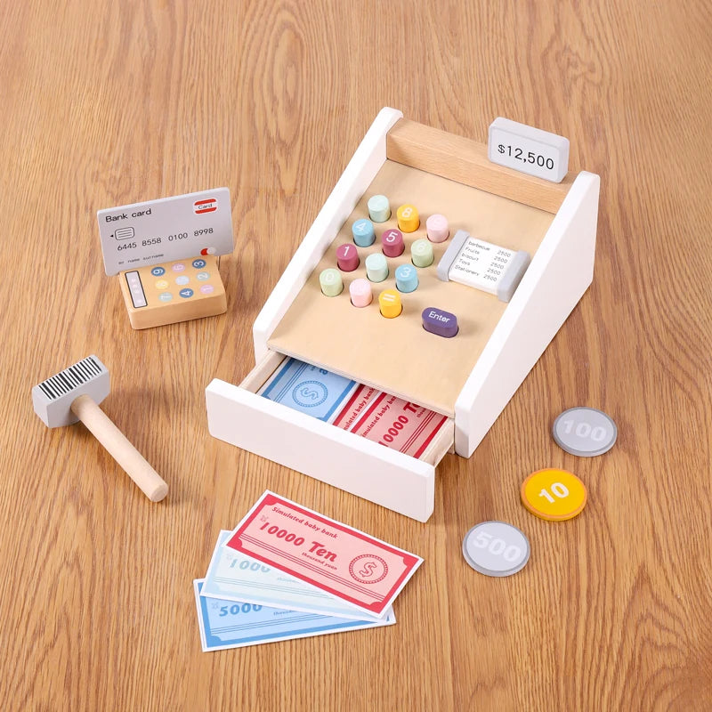 A wooden pretend play supermarket checkout counter with a cash register and various plastic coins and paper money.