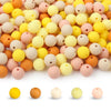 A collection of round, flexible silicone beads in various pastel and earthy colors for DIY jewelry making.