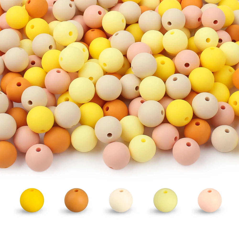 A collection of round, flexible silicone beads in various pastel and earthy colors for DIY jewelry making.