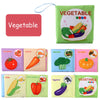 A set of soft cloth books featuring various vegetables like tomatoes, carrots, broccoli, pumpkin, corn, bell peppers, and egg