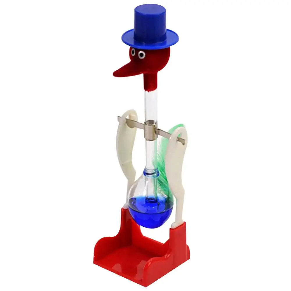 A red and blue drinking bird toy with a clear glass tube and base for desk decor.