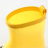 A bright yellow kids rain boot with a ribbed cuff and smooth body.