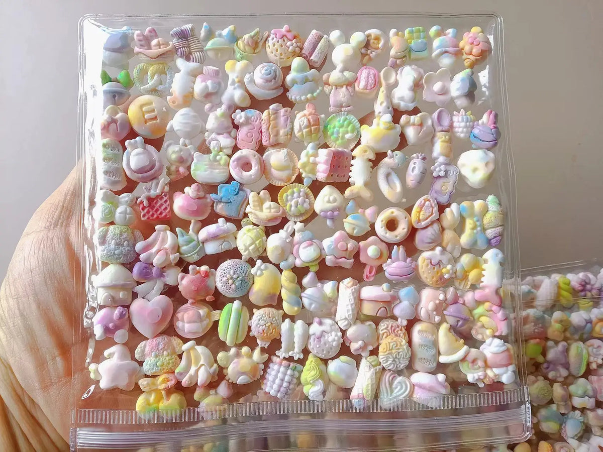A clear plastic container filled with colorful kawaii cat paw squishy stress relief fidget toys.