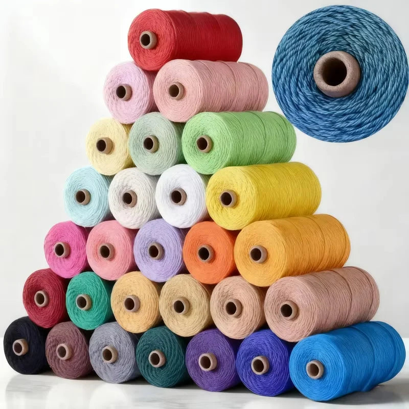 A collection of spools of 3mm cotton macrame cord in various shades of pink, green, yellow, and blue.