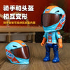 A miniature toy car race helmet collectible in blue and orange colors displayed on a wooden surface.