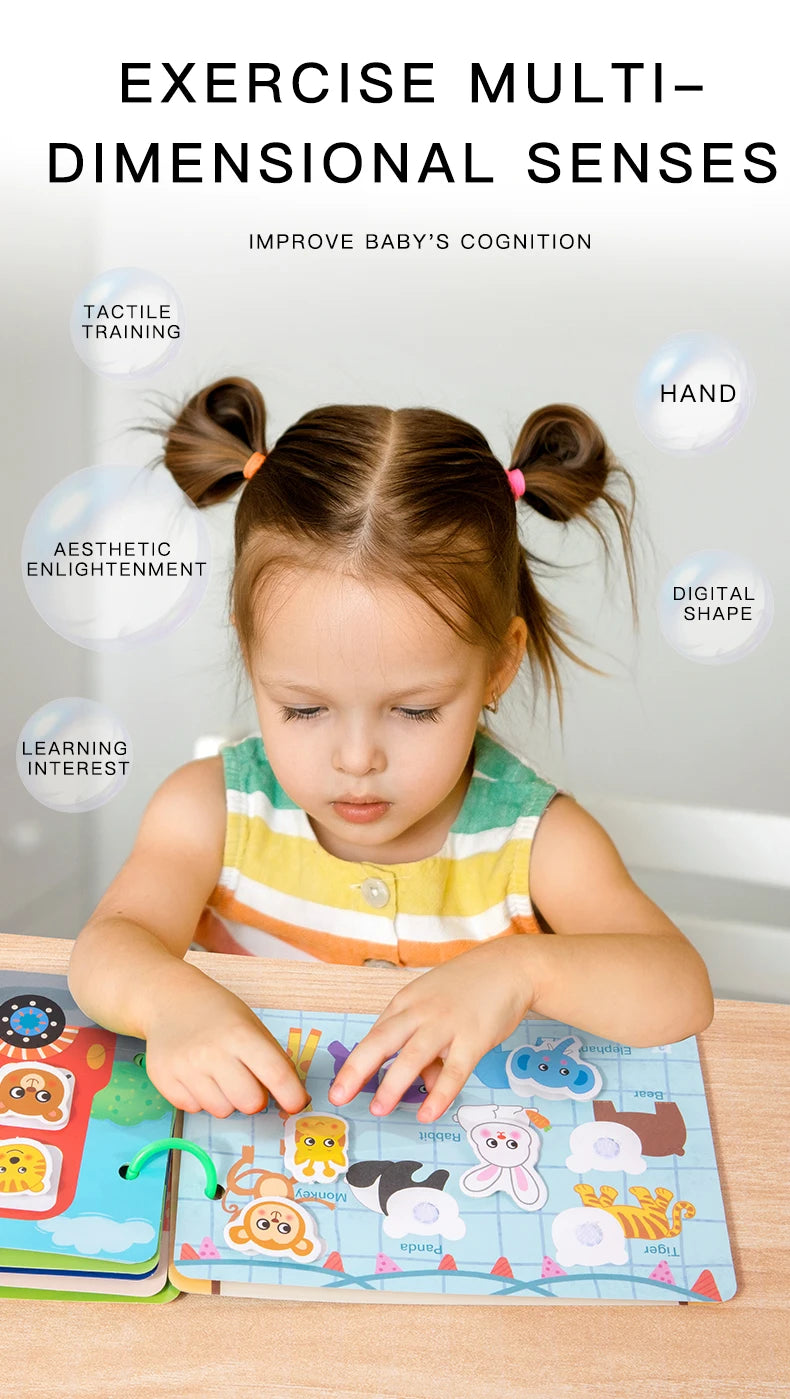 A young child is interacting with an interactive quiet book featuring animal stickers and shapes for cognitive development.