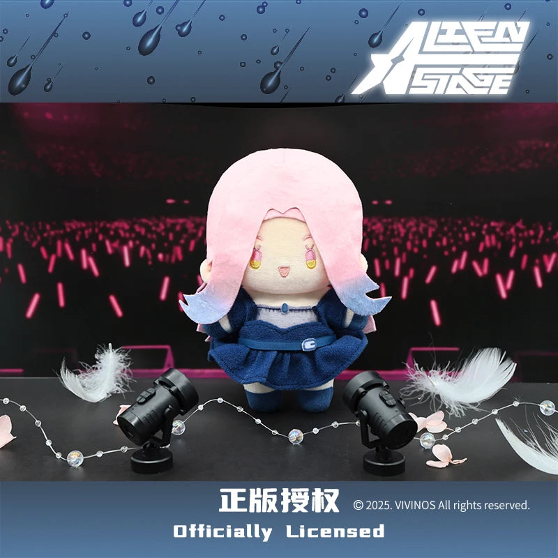 A plush doll with pink hair and blue clothing is displayed against a dark background.