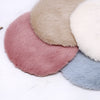 A collection of handwoven Turkish style miniature carpet mats in various shades of pink, beige, and blue.