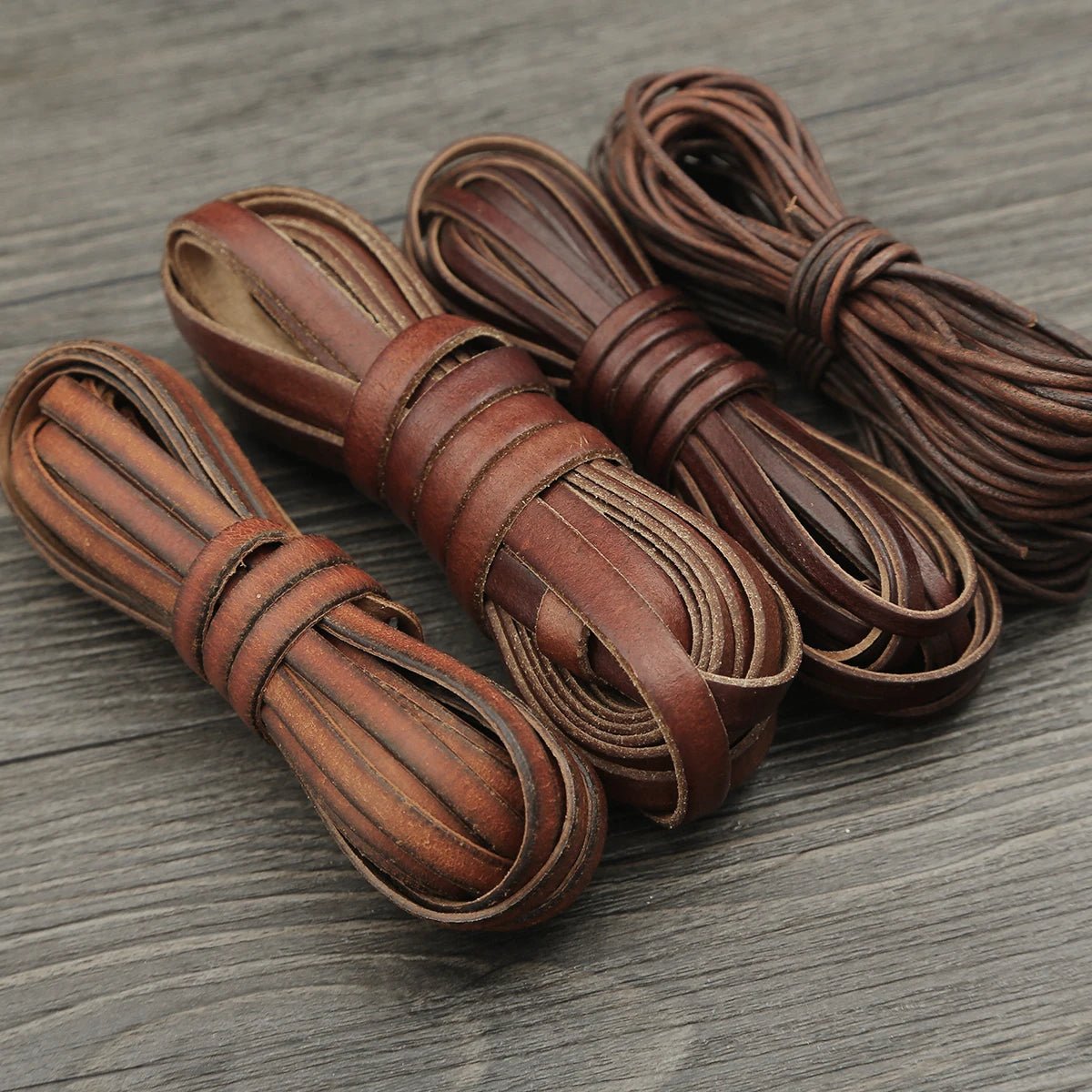 Several bundles of brown faux leather cords used for DIY jewelry making