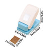 A light beige lever action embosser tool with a square embossing plate and a blue base.