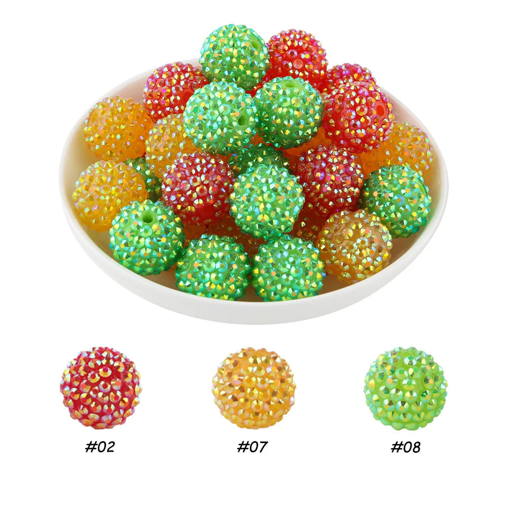 A bowl filled with various colored rhinestone resin bayberry ball beads including red, orange, and green.