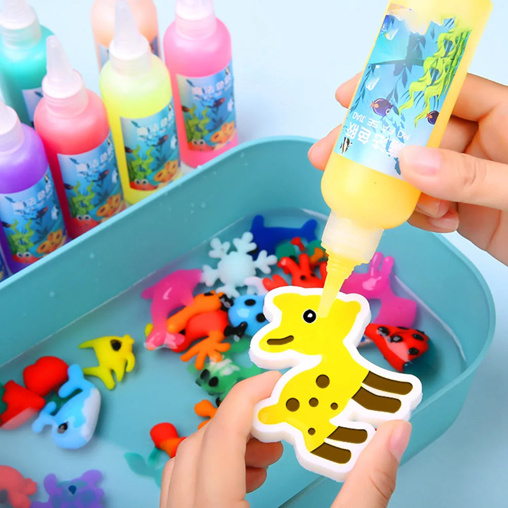 Hands are dipping a yellow liquid into a squeeze bottle for a Magic Water Elf DIY craft kit with assorted gel molds.