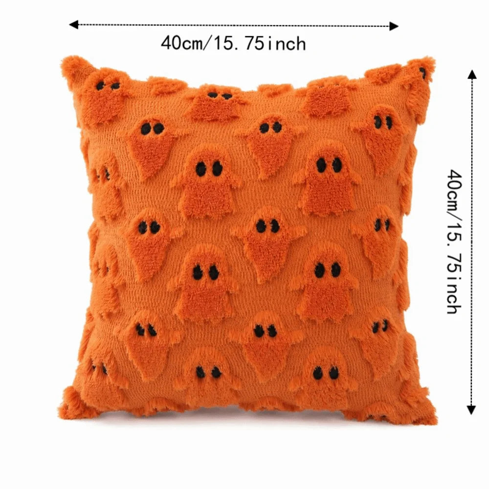 Orange textured pillow covers featuring a pattern of black ghost faces for Halloween decoration