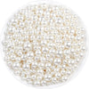 A pile of small, round ivory pearl beads for DIY jewelry making.