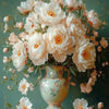 A bouquet of white and peach flowers arranged in a vase on a wooden surface.