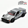 A silver diecast model of a Toyota AE86 sports car with racing decals and aftermarket wheels.