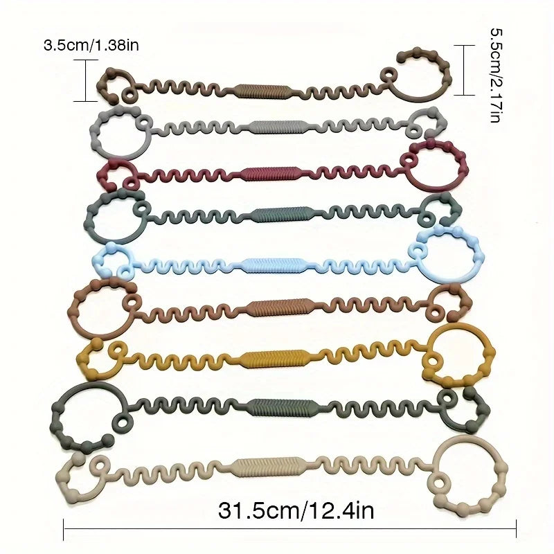 Un ensemble de tétines anti-chute en silicone de différentes couleurs et tailles, affichées horizontalement.