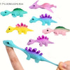 A collection of colorful mini dinosaur finger slingshots in various shades and colors shown against a white background.