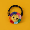 Handmade crochet sunflower decorative smile orb with colorful petals and black string