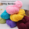 A stack of pink, yellow, and purple Merino wool yarn skeins for knitting and crafting.
