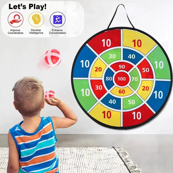 A child is playing an interactive sticky ball dart game on a circular target board with colored scoring zones.
