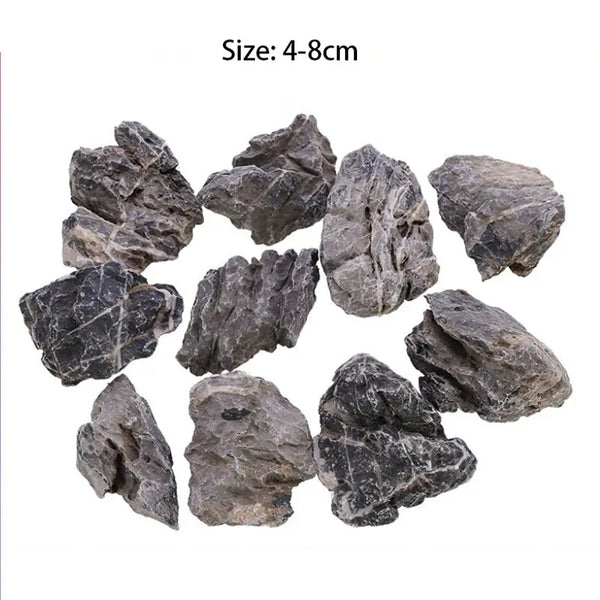 A collection of rough, dark gray natural stone rocks for aquarium decor, sized between 4 and 8 centimeters.