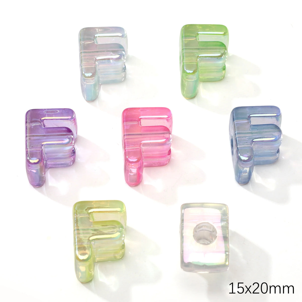 A collection of colorful acrylic letter beads in various shades including purple, pink, and blue.