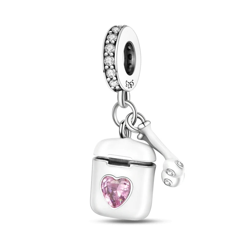 A silver heart charm bead with pink zircon stones and a bail, suspended from a chain.