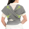 A person wearing a gray ergonomic multi-functional baby sling carrier, demonstrating its folding design.