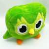 A plush toy of Duo the Owl, a soft green stuffed animal with large eyes and yellow beak.