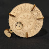 A round wooden puzzle featuring intricate star and geometric designs, intended as a DIY model building set.