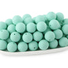 A pile of light mint green round silicone beads for jewelry making and DIY crafts.