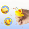 A hand holds a yellow silicone duck bath toy with a straw, demonstrating the squeaky floating duck.